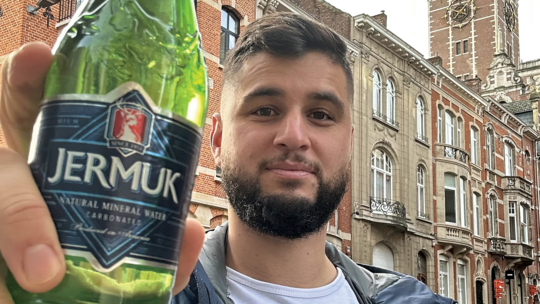 Rouben Koulaksezian shows off a bottle of Jermuk mineral water he found on his travels through Brussels. Photo Credit: Rouben Koulaksezian